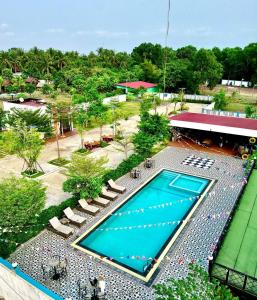 an overhead view of a swimming pool with lounge chairs and a resort at Damnak Borey Resort in Kampot