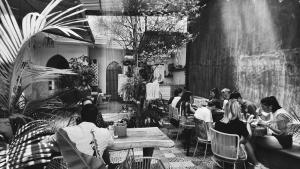 a group of people sitting at tables in a restaurant at Hoja Santa Posada in Cholula