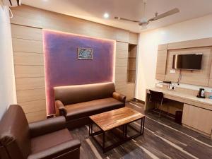 a living room with a couch and a table at Hotel Starway in Balasore