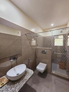 a bathroom with a toilet and a sink and a shower at Hotel Starway in Balasore