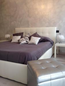 a bedroom with a large bed with a white headboard at B&B Oro Puro in Fondi