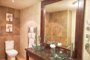 a bathroom with two sinks and a toilet at Torc Hotel in Killarney +17 photos