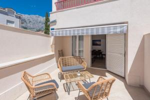 a patio with chairs and a table on a balcony at Apartments Mari - 40m from the beach in Makarska