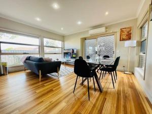 a living room with a table and chairs at Tranquil Retreat near to Airport in Melbourne
