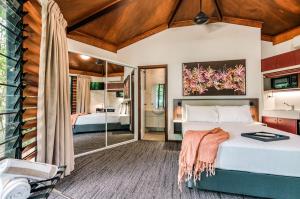 a bedroom with a bed and a bathroom at Palms City Resort in Darwin