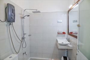 a bathroom with a shower and a sink at Blooming Holiday Resort in Anuradhapura +40 photos