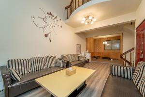 a living room with couches and a table at Qilin Valley in Puli