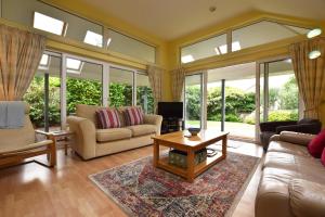 a living room with a couch and a table at Glan Helyg in Newport