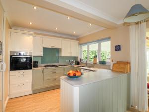 a kitchen with a bowl of fruit on a counter at Glan Helyg in Newport