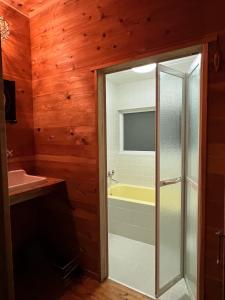 a bathroom with a shower and a sink at Sai Holiday House Ohama Beach - Max 9 ppl in Shimoda