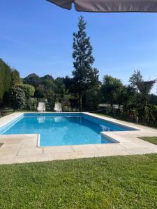 a swimming pool in the middle of a yard at Fonte do Forno Villas in Afife