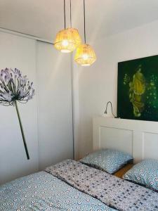 a bedroom with a bed and two pillows and a flower at Plein centre de Beaulieu in Beaulieu-sur-Mer