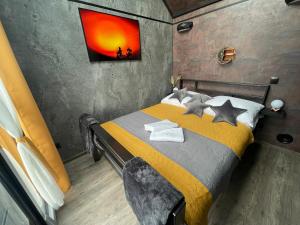 a bedroom with a bed with a painting on the wall at Moon Hill's Lord in Jeżów Sudecki