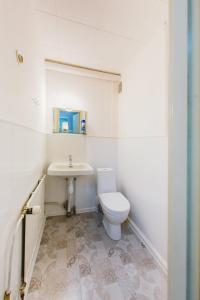 a white bathroom with a toilet and a sink at YH Lappeenranta in Lappeenranta +18 photos