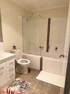 a white bathroom with a toilet and a shower at Townhouse in Franklin in Harrison +18 photos