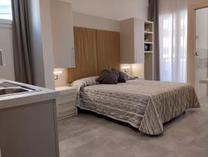 a bedroom with a bed and a sink in it at Hotel Abel & Residence in Cesenatico