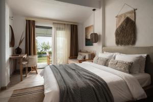Postel nebo postele na pokoji v ubytování Bungalows Iphigenia