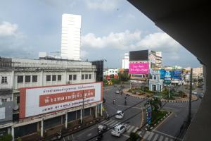 a busy city street with cars on the road at Green Leaf Hostel in Phuket Town