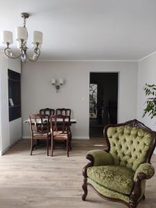 a living room with a chair and a table at Amrai in Ventspils