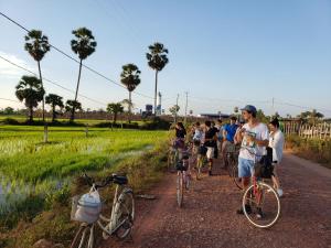 a group of people riding bikes on a dirt road at Onederz Siem Reap in Siem Reap