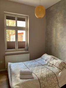 Posteľ alebo postele v izbe v ubytovaní Apartament Pod Haffnerem