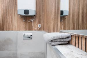 a bathroom with a sink and a towel at Apartamenty Zabrska 45 in Gliwice