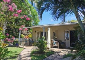 a cottage with a garden and a patio at Eight Palms in Port Edward