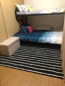 a bedroom with a bunk bed and a rug at Cozy Home 1 bedroom in Manila