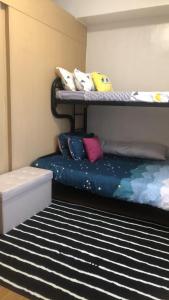 a bedroom with two bunk beds with pillows on it at Cozy Home 1 bedroom in Manila