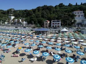 a large group of chairs and umbrellas on a beach at B&B Vista Mare in Rodi Garganico