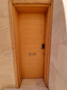 a wooden door in a room with a wall at 1 Bedroom, Pool view and 2 balconies, Scarab Club in Hurghada