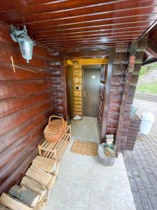 a porch of a log cabin with two chairs at Dwarfs cabin overlooking Julian Alps near Bled in Jesenice