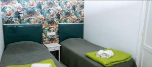 a small room with two beds with towels on them at Playa del ingles Tamaran apartamento 509 in Maspalomas +17 photos
