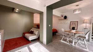a living room with a table and a couch at L'Indépendant in Nemours