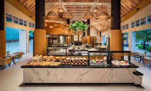 a bakery with a bunch of pastries on display at JW Marriott Maldives Resort & Spa in Funadhoo