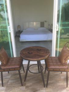 a table and two chairs in a room with a bed at Chiang Khan Riverside Bungalows in Chiang Khan