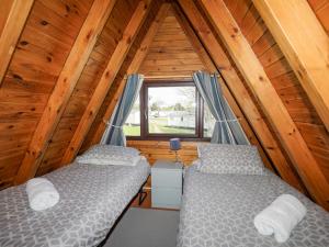 a bedroom with two beds in a wooden cabin at 171 Snowdonia View in Pwllheli