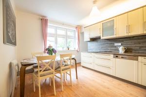 a kitchen and dining room with a table and chairs at Vila Lumír in Poděbrady