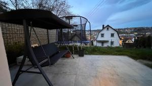 a patio with a chair and a basketball hoop at Emily’s Apartment in Blaustein