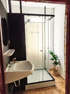 a bathroom with a glass shower and a sink at Lounge-Style-Hostel in Sankt Veit an der Glan
