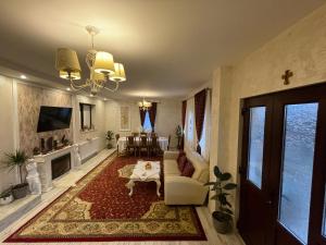 a living room with a couch and a table at Casa cu Pitici in Vama