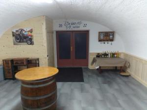 a room with a barrel and a table and a door at Gästehaus Josef Lang in Andau