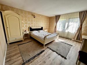 a bedroom with a bed and a large window at Complex Popas Pacurari in Iaşi