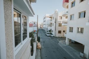 an empty street in a city with buildings at Aladdin's Hostel in Larnaca +10 photos