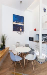 una sala da pranzo con tavolo e sedie bianchi di FLH Graça Lovely Apartment II a Lisbona