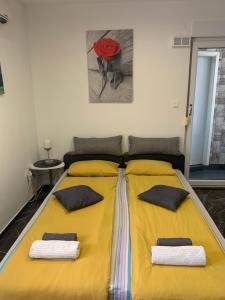 a large yellow bed with two pillows on it at Studio DAMA blizina amfiteatra i bus kolodvora ,privatan parking ,Self-Check- In in Pula