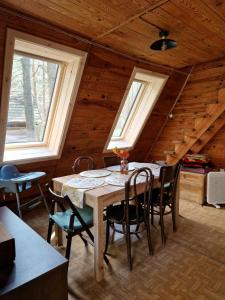 uma sala de jantar com uma mesa e cadeiras num camarote em Leśna Chatka em Wola Polska