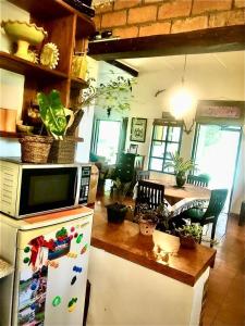 a kitchen with a microwave on top of a refrigerator at Captain's Bungalow, Kandy in Arawwawala