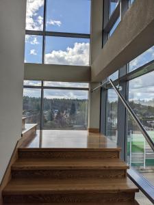 a staircase in a building with large windows at Hotel Morski in Gdynia