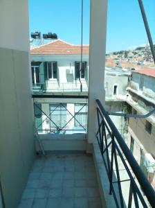 a balcony with a view of a building at Cozy studio flat 1 bedroom-Very central location in Mytilini